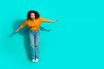 Full size photo of careless astonished woman dressed orange shirt look down at proposition empty space isolated on teal color background