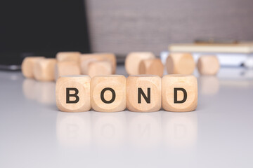 A financial and investment concept depicted with wooden blocks spelling out the word Bond