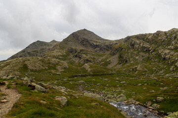Mountain summit Spronser Rötelspitze in the clouds in Texel group, South Tyrol, Italy