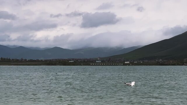 Sevan lake, Armenia. Idyllic scene with mountains and cloudy sky landscape