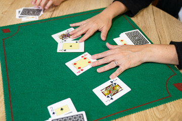 A woman is playing a card game with a man