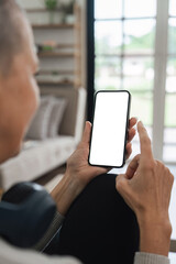 Senior Woman Using Smartphone at Home with Blank Screen for Mockup or App Presentation