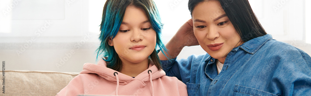 Wall mural Asian mother and her teenage daughter with blue hair together at home.