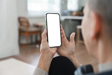 Person Holding Smartphone with Blank Screen in Modern Home Interior, Ready for Custom Content or App Display