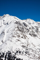 Snowy mountain peaks of Elbrus and nearby peaks in winter on a sunny day
