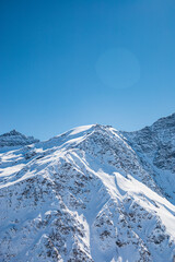 Snowy mountain peaks of Elbrus and nearby peaks in winter on a sunny day
