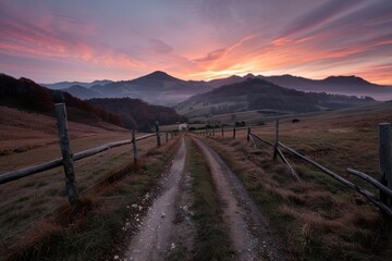 A rustic country road lined by wooden fences stretches into the distance under a mesmerizing sunset sky, capturing the essence of rural simplicity and peacefulness.