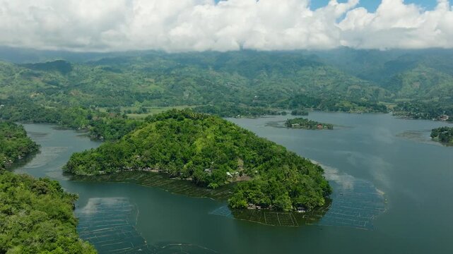 Birds eye view of Lake Sebu and mountain with forest, jungle and trees. Blue sky and clouds. Mindanao, Philippines.