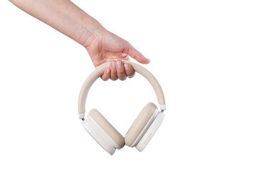 Woman holding a beige color modern wireless headphones