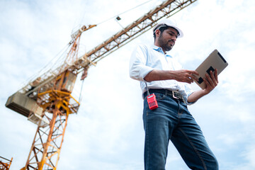 Portrait of engineer with tower crane for lift and move objects on building construction sites