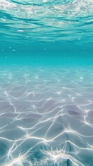 Fototapeta premium Turquoise water with sunlit sandy ocean floor patterns