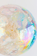 iridescent soap bubble, delicate and transparent with intricate details reflecting light in soft pastel hues, set against a white background