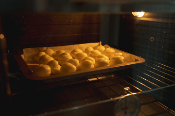 A close up of homemade choux cream baking in the oven, concept of bakery recipe, kitchen and preparation, dessert culinary, vanilla and creamy. golden. french pastry.