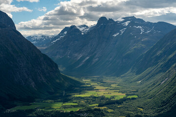 View from the top of Romsdalseggen trail in Andalsnes down to the fjords and the Rauma river with fjords in the background