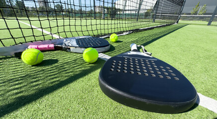 Paddle tennis still life. Racket, balls and turf