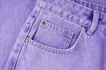 Front pocket, small pocket, details of  purple jeans pants close up, macro