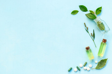 Healing fresh herbs and essential oil in glass bottles. Alternative herbal medicine concept