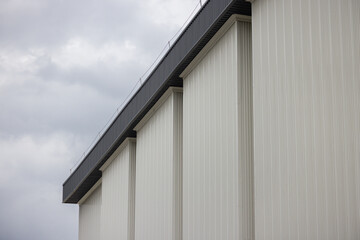 A white building with a grey sky in the background