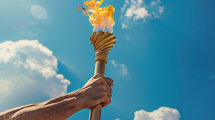  A man's muscular arm holds a torch with the Olympic flame, a blue sky background with clouds 