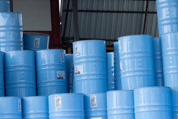 A stack of blue barrels with stickers on them