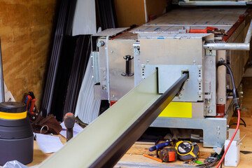 An automatic bending machine is used to bend rain gutters made of thin metal