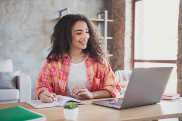 Photo of pretty cheerful lady wear checkered shirt distance education modern device indoors room home house