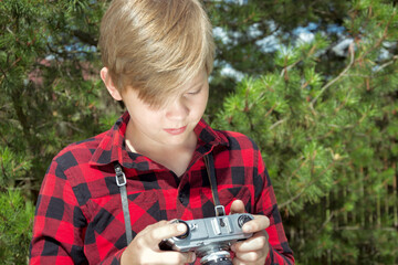 Teenager study and taking photos in the public park. Outdoors. Close up. Summer.