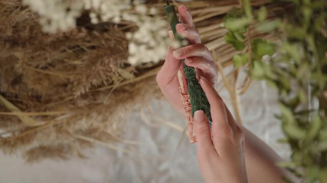 occult objects. an occult candle in a woman's hands. mysticism, occultism, magic. vertical shot of a candle in a woman's hands
