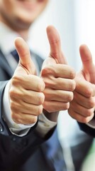 Smiling businessman giving double thumbs up gesture
