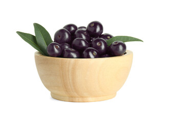 Fresh ripe acai berries in bowl and green leaves isolated on white