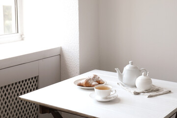 Croissants and tea on table in studio. Professional food photography