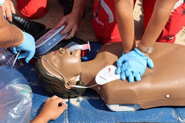 Exercise by Red Cross nurses and doctors on an Italian beach. Cardiac massage on a mannequin....