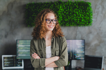 Photo of lovely cheerful cute nice woman software developer crossed arms modern workspace...