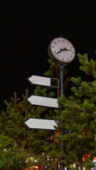 street clock with pointer signs and arrows