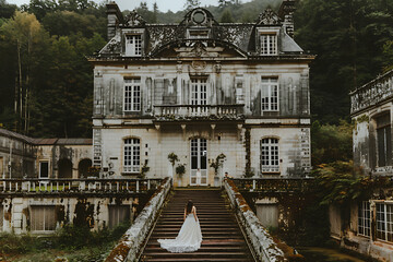 Bride standing on the steps of an old European castle