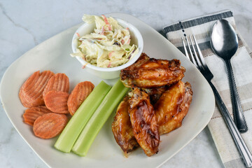 chicken wings  with carrots and celery