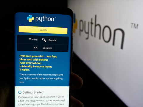 Stuttgart, Germany - 07-17-2024: Person holding cellphone with webpage of organisation Python Software Foundation (PSF) in front of logo. Focus on center of phone display.