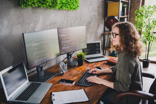 Photo of lovely nice successful woman coder hacker sitting working armchair comfortable workspace workstation indoors