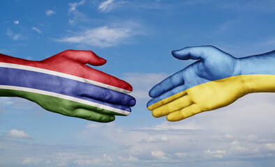 Ukraine and Gambia country handshaking with flags, consensus concept international co-operation illustration