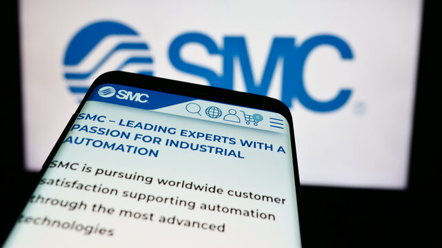 Stuttgart, Germany - 07-25-2024: Mobile phone with website of Japanese machinery company SMC Corporation in front of business logo. Focus on top-left of phone display.