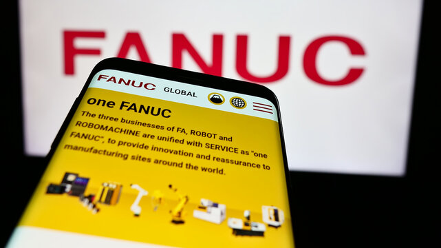 Stuttgart, Germany - 07-25-2024: Mobile phone with website of Japanese robotics company FANUC Corporation in front of business logo. Focus on top-left of phone display.
