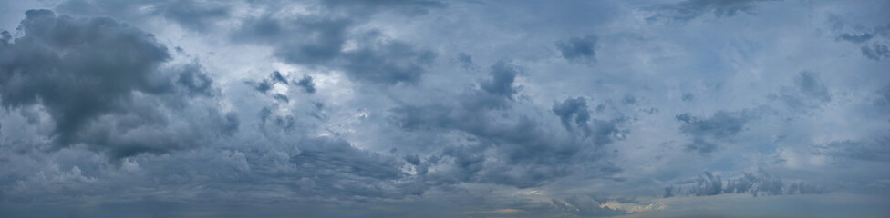 Russia, south of Western Siberia. Panoramic view of the evening sky with the setting sun and colorful clouds.