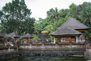 Sacred grounds of a Balinese temple, adorned with traditional structures and lush greenery.