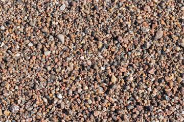 Coarse wet sand on the beach. Top view