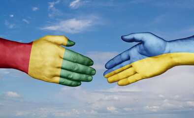 Ukraine and  Guinea-Conakry country handshaking with flags, consensus concept international co-operation illustration