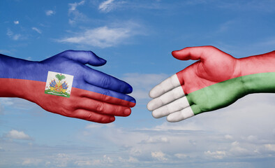 Madagascar and Haiti country handshaking with flags, consensus concept international co-operation illustration