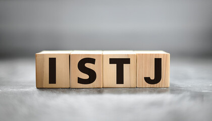 Wooden cubes with text ISTJ. Introversion, Sensing, Thinking, Judging. Personality type. Close-up.