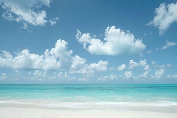 Serene beach with azure waters and fluffy clouds under a clear blue sky, perfect for a relaxing getaway or a tranquil moment.