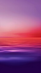 Obraz premium Captivating blend of pink, purple, and red hues dominate the sky, reflected in the tranquil waters of the sea, creating a serene and abstract atmosphere