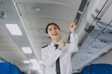 Fototapeta premium Portrait of a trained airplane captain in uniform preparing to fly, event planning in airplane.